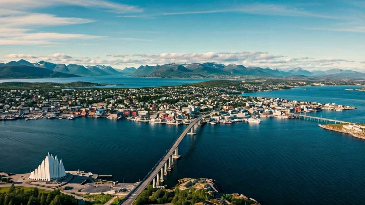 Bird’s-eye drone view of Tromsø, Norway in summer, showing the city island, fjords, and Arctic Cathedral