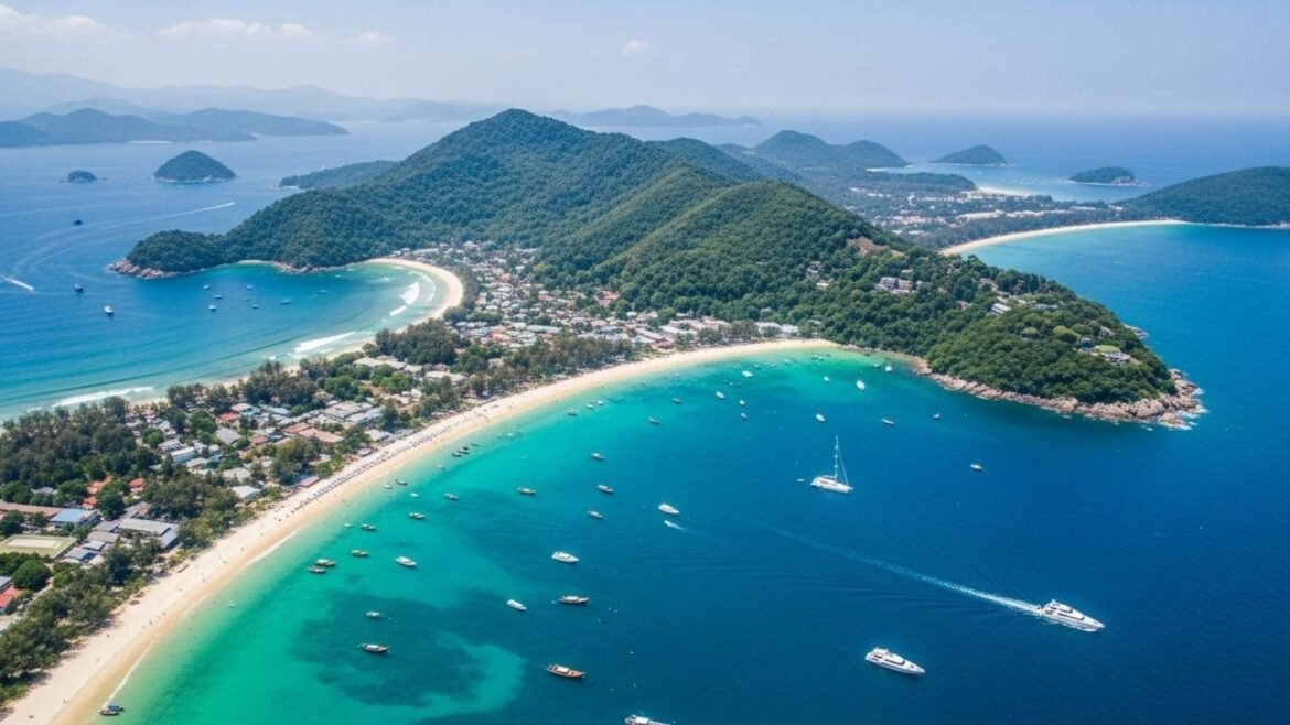 Drone view of Phuket Island with turquoise waters, lush hills, and sandy beaches.