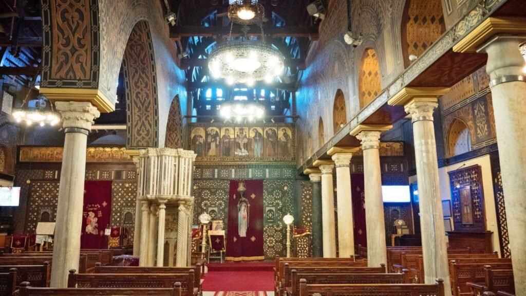 Interior view of the Hanging Church in Coptic Cairo with ancient icons, wooden ceilings, marble columns, and traditional Coptic Christian design.