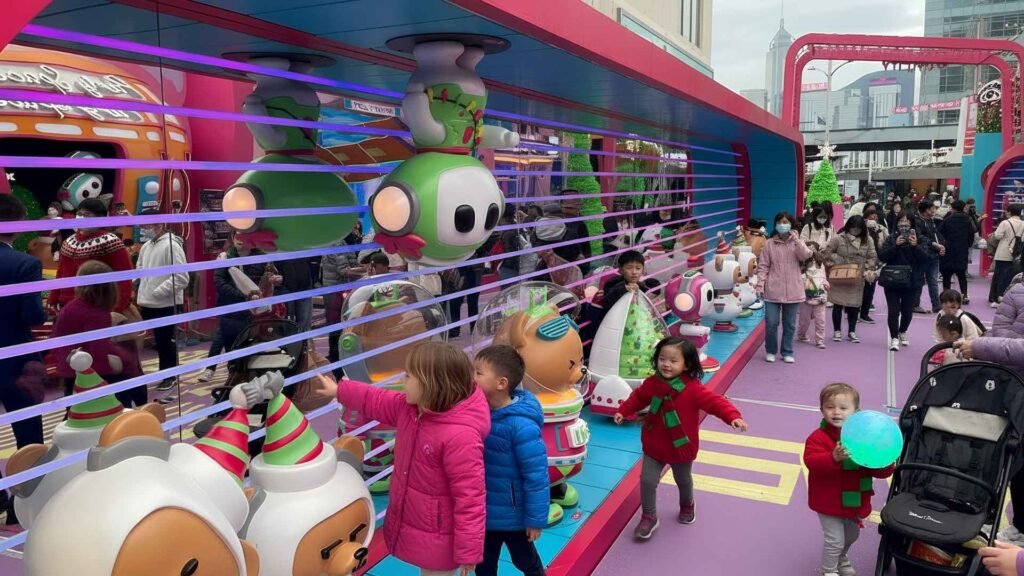 Children enjoying colourful Christmas-themed installations at Harbour City Hong Kong.
