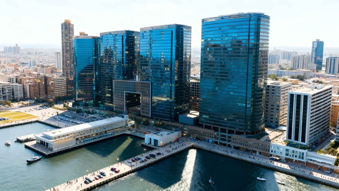 A panoramic aerial view of Harbour City’s blue-glass waterfront towers in Hong Kong.