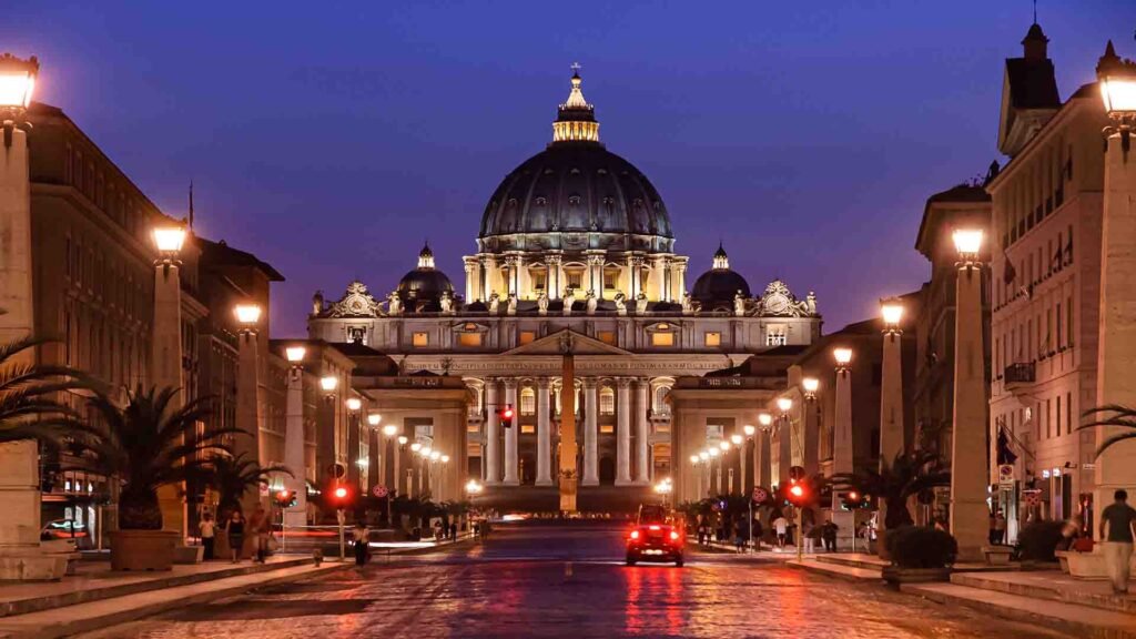 Saint Peter’s Basilica illuminated at night in Vatican City, showcasing its grand dome and majestic architectural details