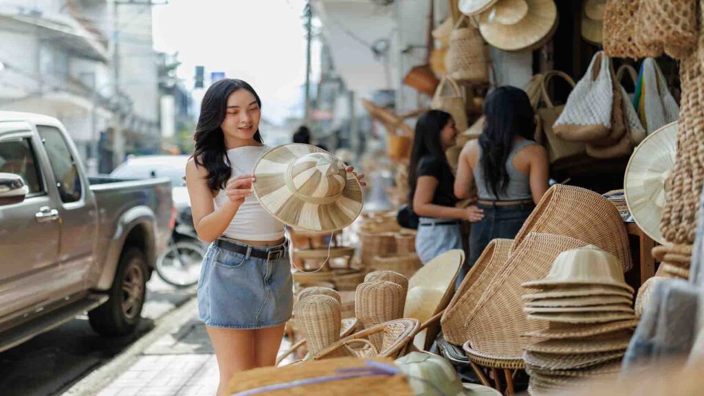 Tourist choosing traditional handmade bamboo products at a local market, showcasing natural materials and artisanal craftsmanship