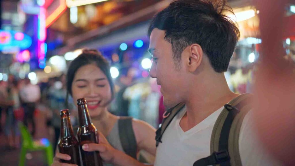 Asian blogger couple exploring Bangkok while traveling together