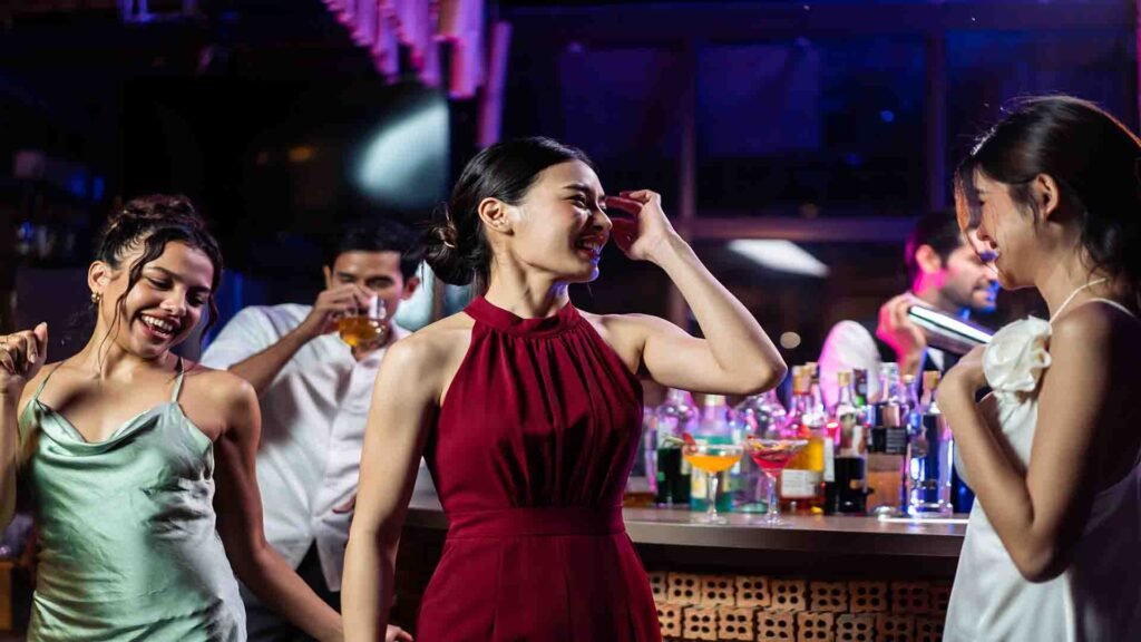 Asian women having fun and socializing together at a bar restaurant