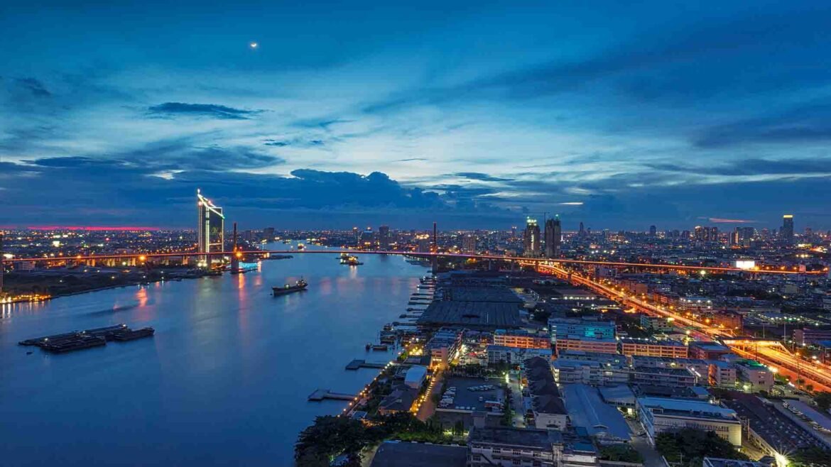 Riverside Nightlife - Rama 9 Bridge spanning the Chao Phraya River at sunset in Bangkok, Thailand