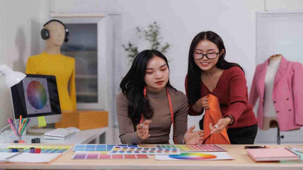 Fashion designers selecting fabric and color for a new clothing collection