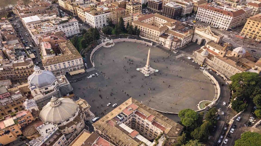 Aerial view of Piazza del Popolo in Rome showcasing its grand symmetry, twin churches, and historic urban layout