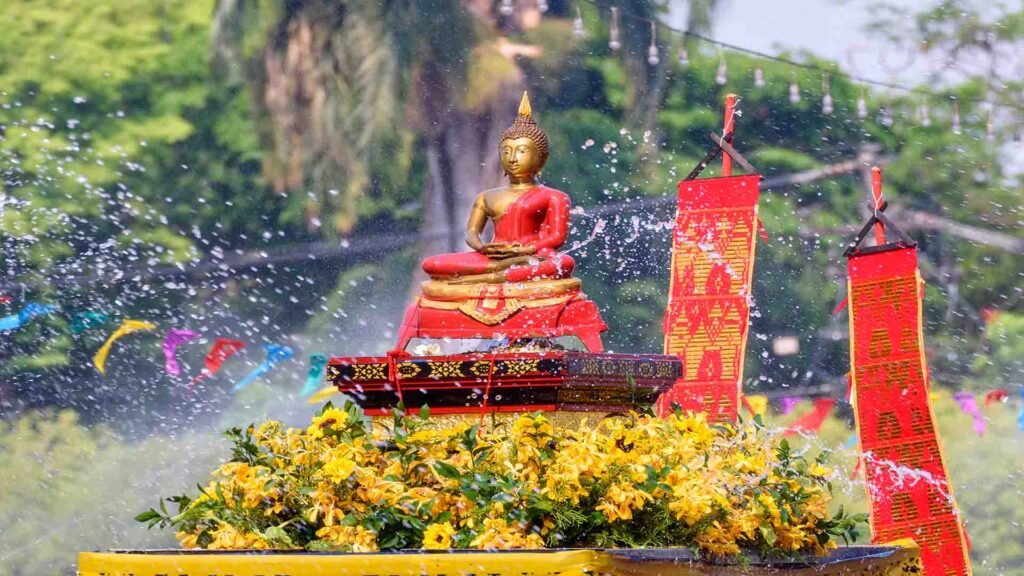 Traditional water pouring ritual during Songkran Festival at a temple in Bangkok