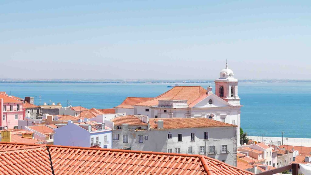 View of Alfama neighborhood in Lisbon, Portugal with historic buildings and narrow streets