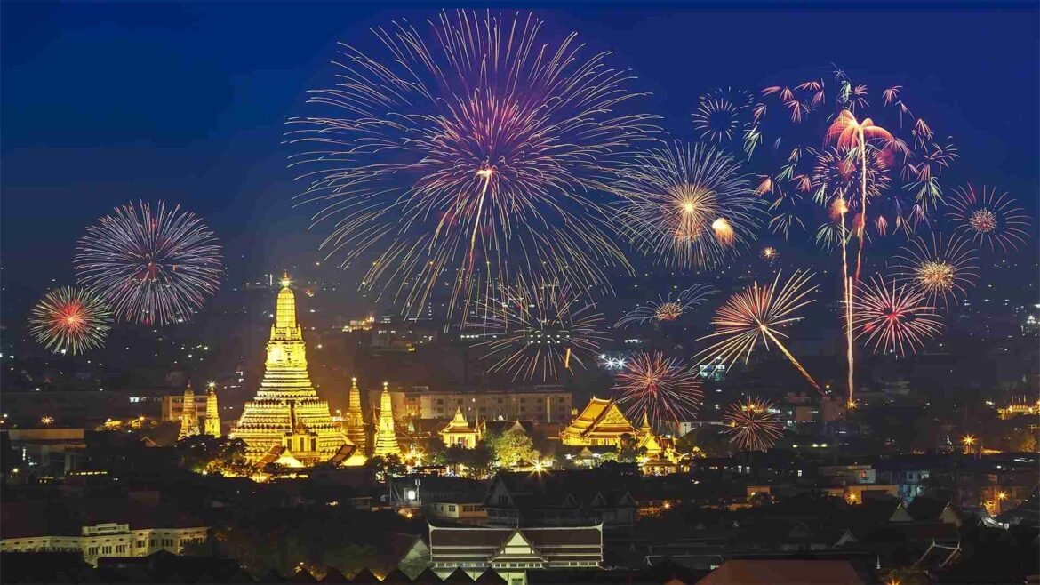 Bangkok New Year Countdown - Wat Arun temple in Bangkok illuminated at night with New Year fireworks