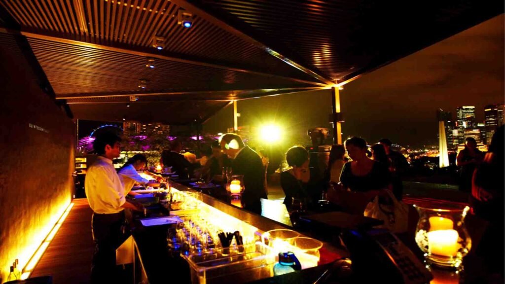 Waterfront bars and lounges with seating overlooking the water in the evening