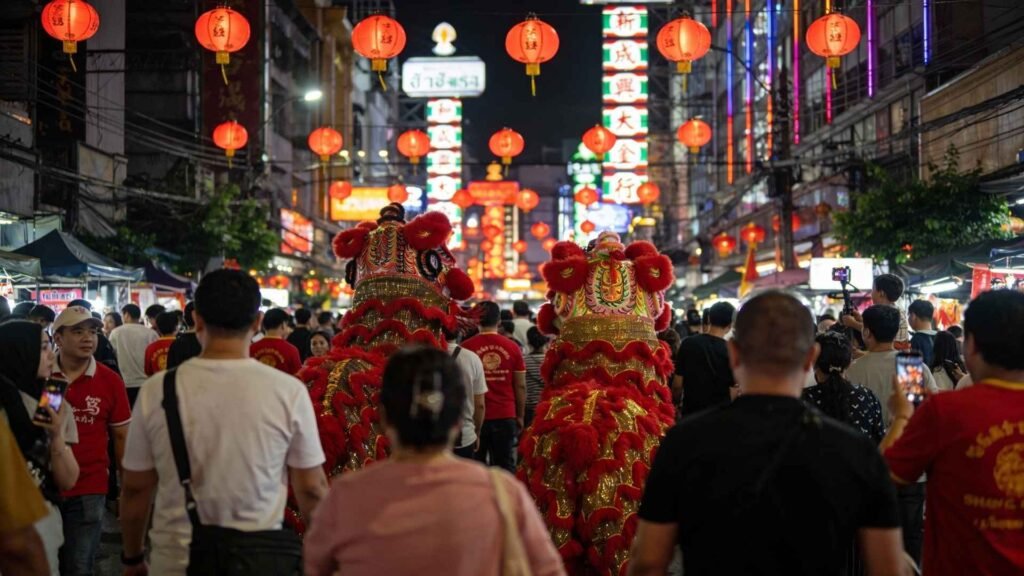 Lion dance performers moving through Yaowarat Road during Chinese New Year celebrations in Bangkok