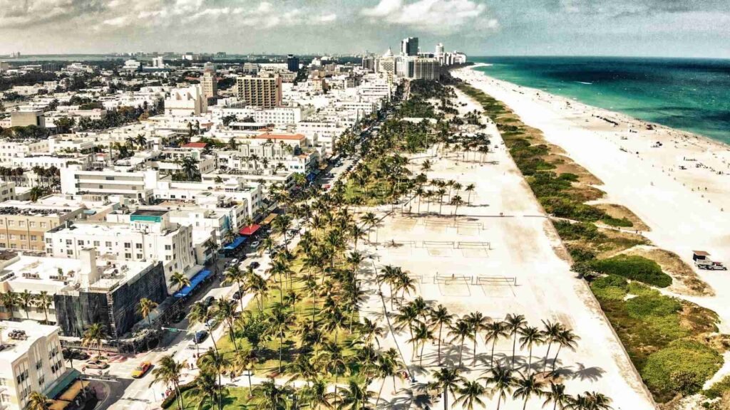Panoramic aerial view of Miami Beach Park and Ocean Drive showing coastline, greenery, and urban beachfront area