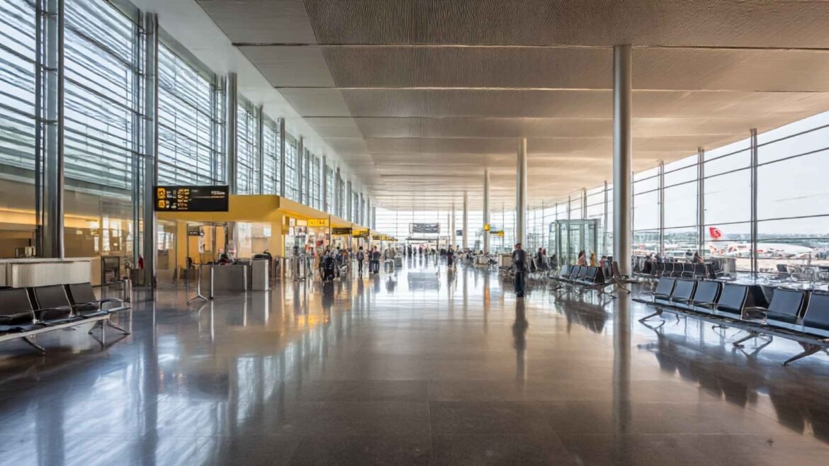 Transit Visa Explained - Bright modern international airport terminal with travelers waiting near departure gates during a daytime transit connection
