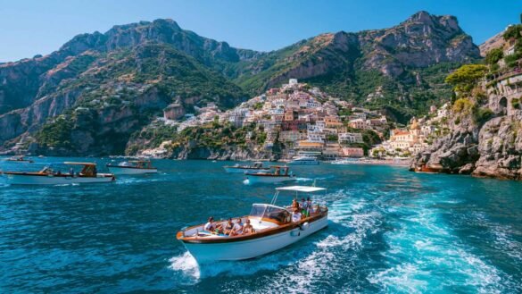 Best Boat Tours in Positano featuring traditional tour boats cruising past the colorful cliffside village along the Amalfi Coast.