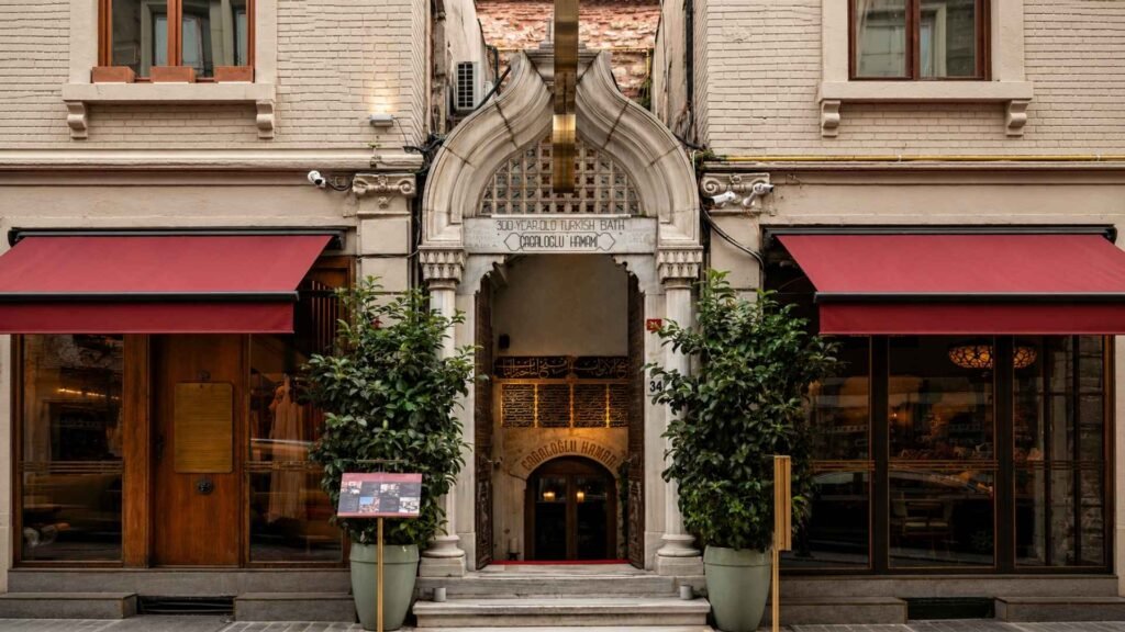 The historic entrance of Cağaloğlu Hamamı in Istanbul, showcasing its ornate Ottoman marble gateway along a narrow street in the Old City.