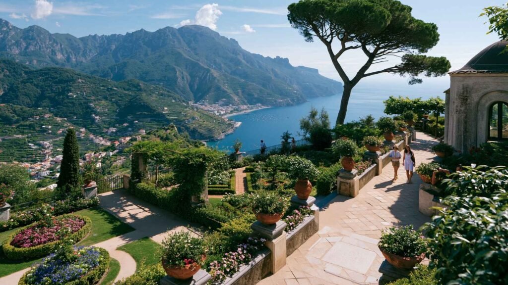 Ravello villa garden terrace overlooking the Amalfi Coast, with manicured flower beds, stone walkways, and panoramic sea views from a historic hillside setting.
