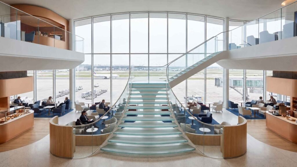 Air France Lounge at Paris CDG Terminal 2F with two-level seating, curved windows and travellers overlooking the airport apron