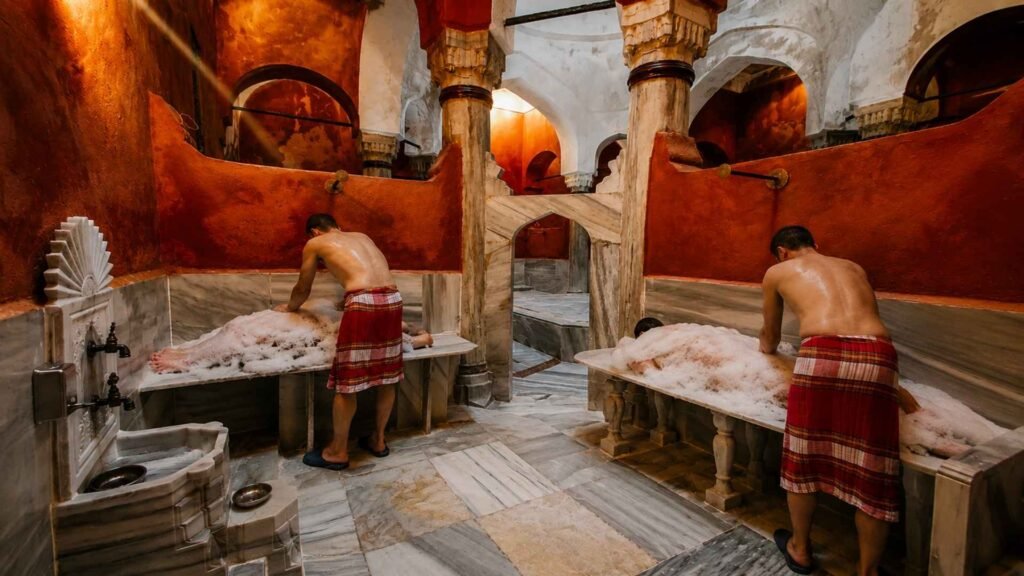 Male attendants performing traditional foam massage on guests during an authentic Turkish bath ritual inside Süleymaniye Hamamı.