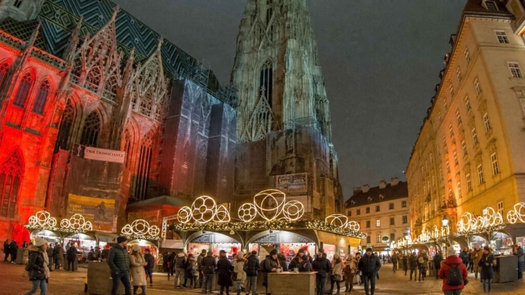 Vienna Christmas Markets at Stephansplatz, with illuminated stalls and visitors beside St Stephen’s Cathedral