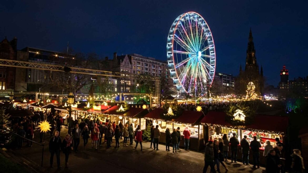 Christmas in Edinburgh with illuminated market stalls, the Ferris wheel and Scott Monument beneath a deep blue evening sky.