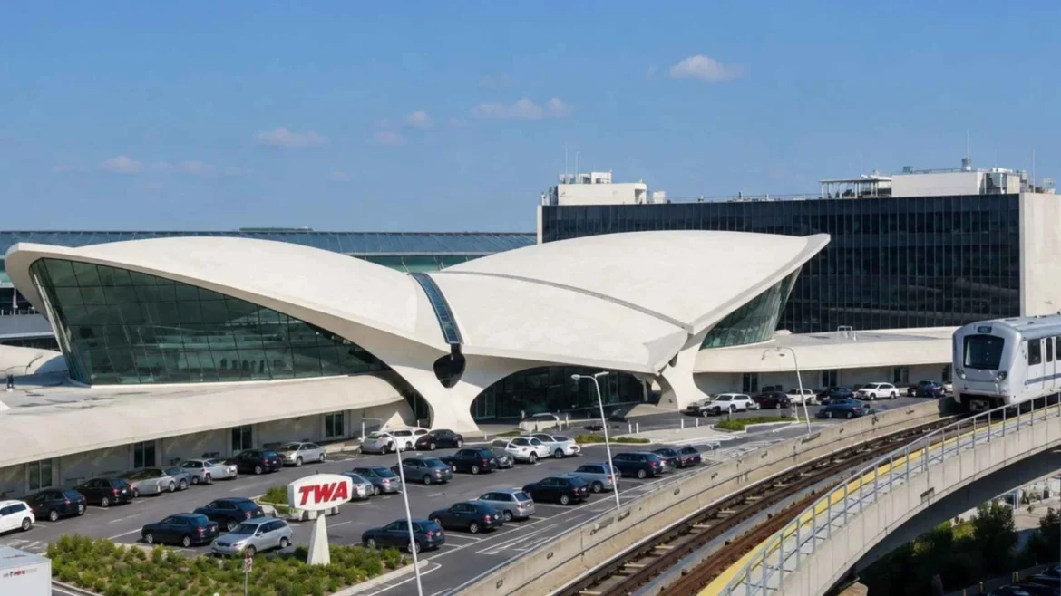 Hotels near JFK Airport: TWA Flight Center exterior with an AirTrain passing in the foreground.