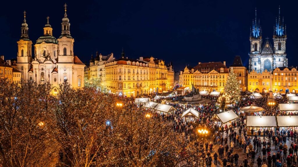 Prague Christmas markets at night, with illuminated stalls and a Christmas tree in Old Town Square